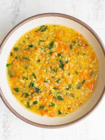 Red lentil soup with carrots in a bowl.