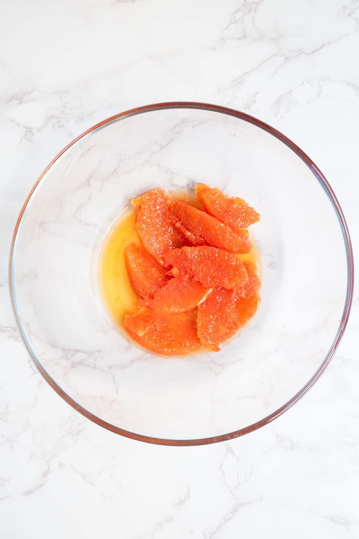Segmented orange slices in a glass bowl.