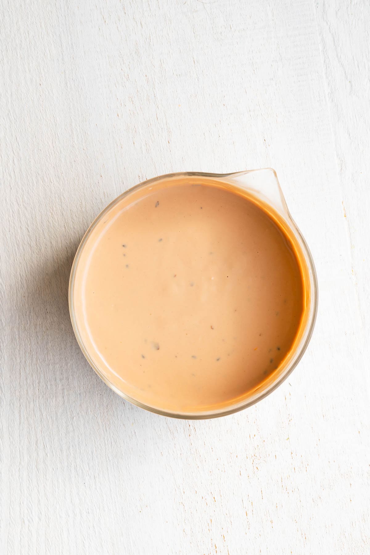 Tahini salad dressing in a glass bowl.