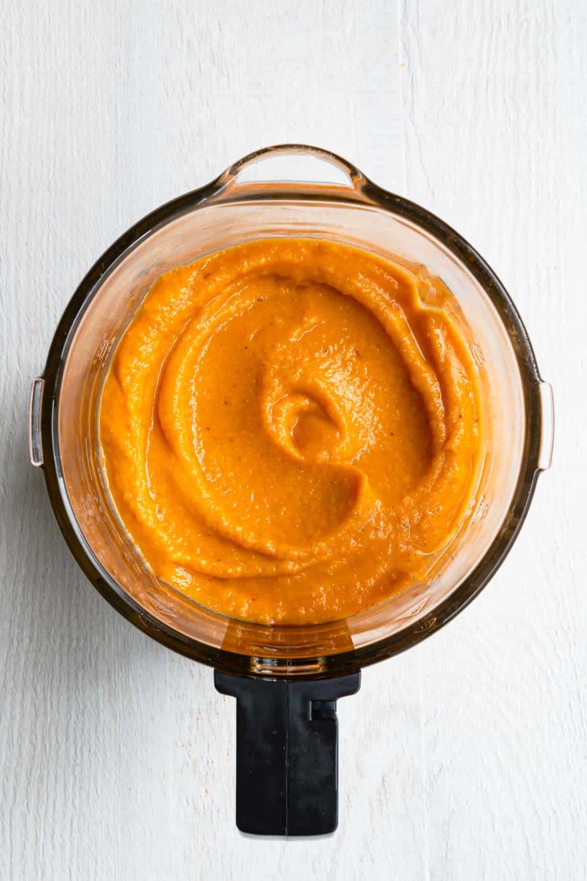 Creamy orange pasta sauce in a blender.