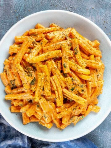 Creamy butternut squash pasta sauce with pasta in a bowl.