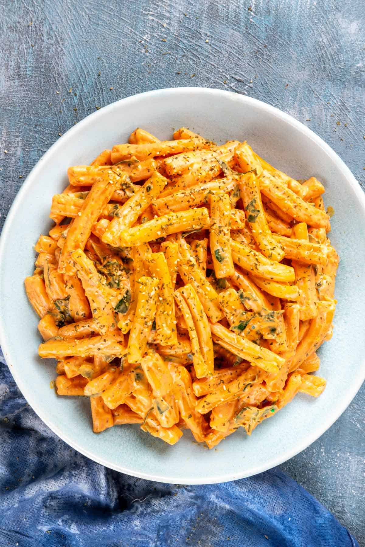 Creamy butternut squash pasta sauce with pasta in a bowl.