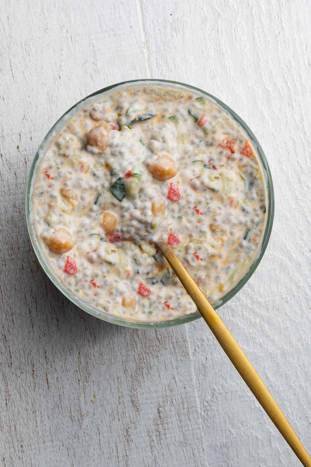 Mediterranean breakfast chia pudding with yogurt in a glass bowl.