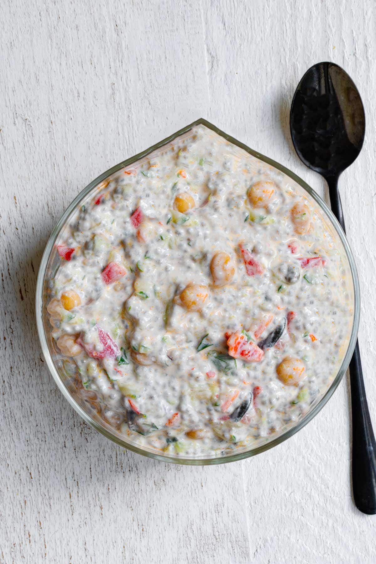 Mediterranean breakfast chia pudding with yogurt in a glass bowl.