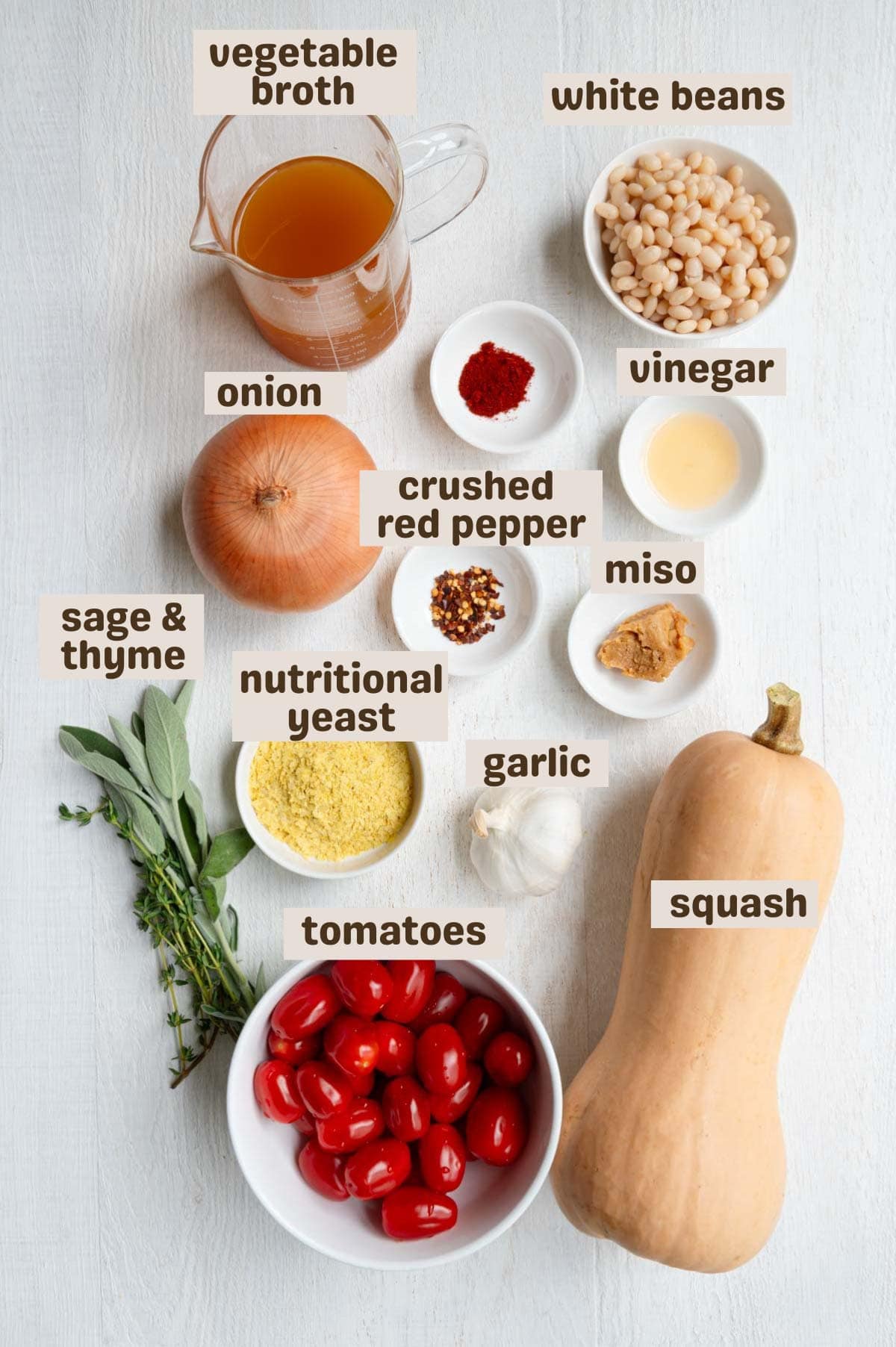 White beans, miso, butternut squash, onion, nutritional yeast, spices, chili flakes, cherry tomatoes, broth, garlic, fresh sage, and fresh thyme.