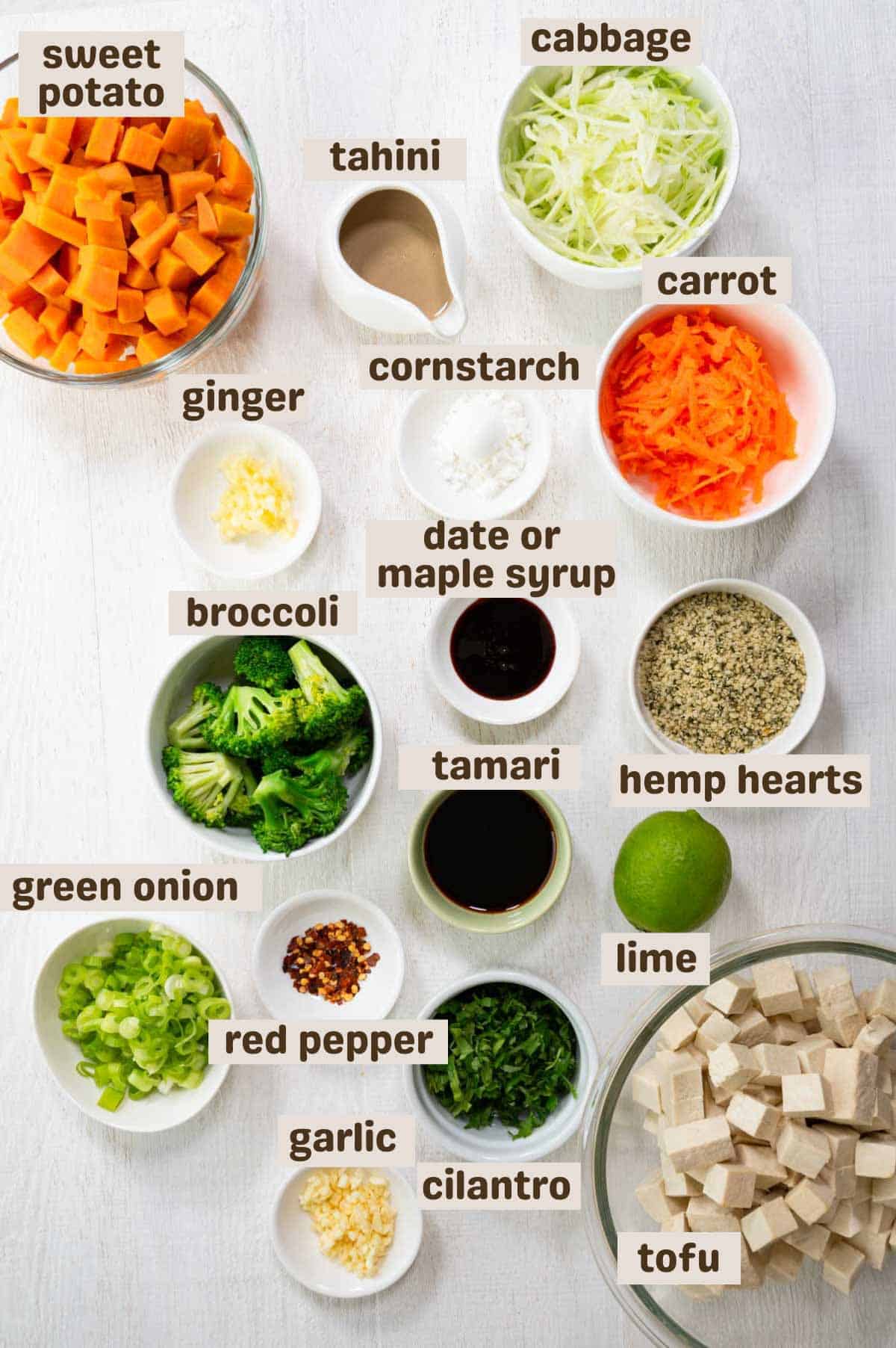 Cubed sweet potato, grated carrots, sliced cabbage, hemp hearts, cilantro, tofu cubes, lime, green onion, broccoli, red pepper, tamari, ginger, garlic, date syrup, cornstarch, and tahini.
