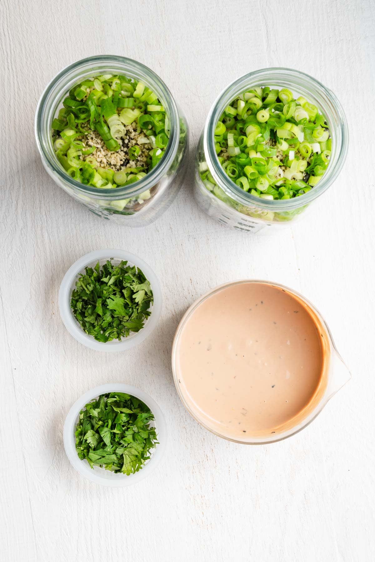 Meal prep salad jars with tahini dressing.