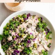 Protein Lentil quinoa salad in a white bowl topped with tahini dressing.