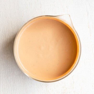 Light tahini dressing in a glass bowl.