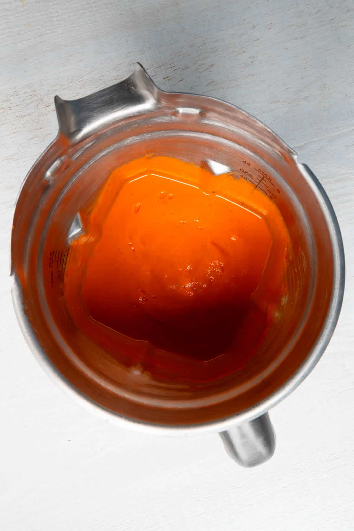 Blended paprika sauce in metal blender.
