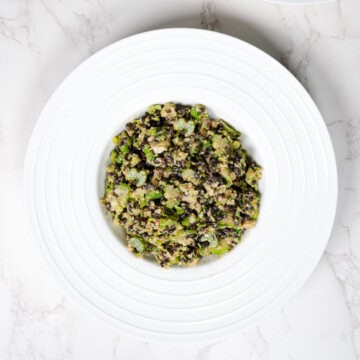 Shaved Brussels Sprouts & Celery Anti-Cancer Salad in a white bowl.
