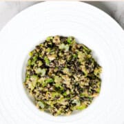 Shaved Brussels and Celery Anti-Cancer Salad in a white bowl.