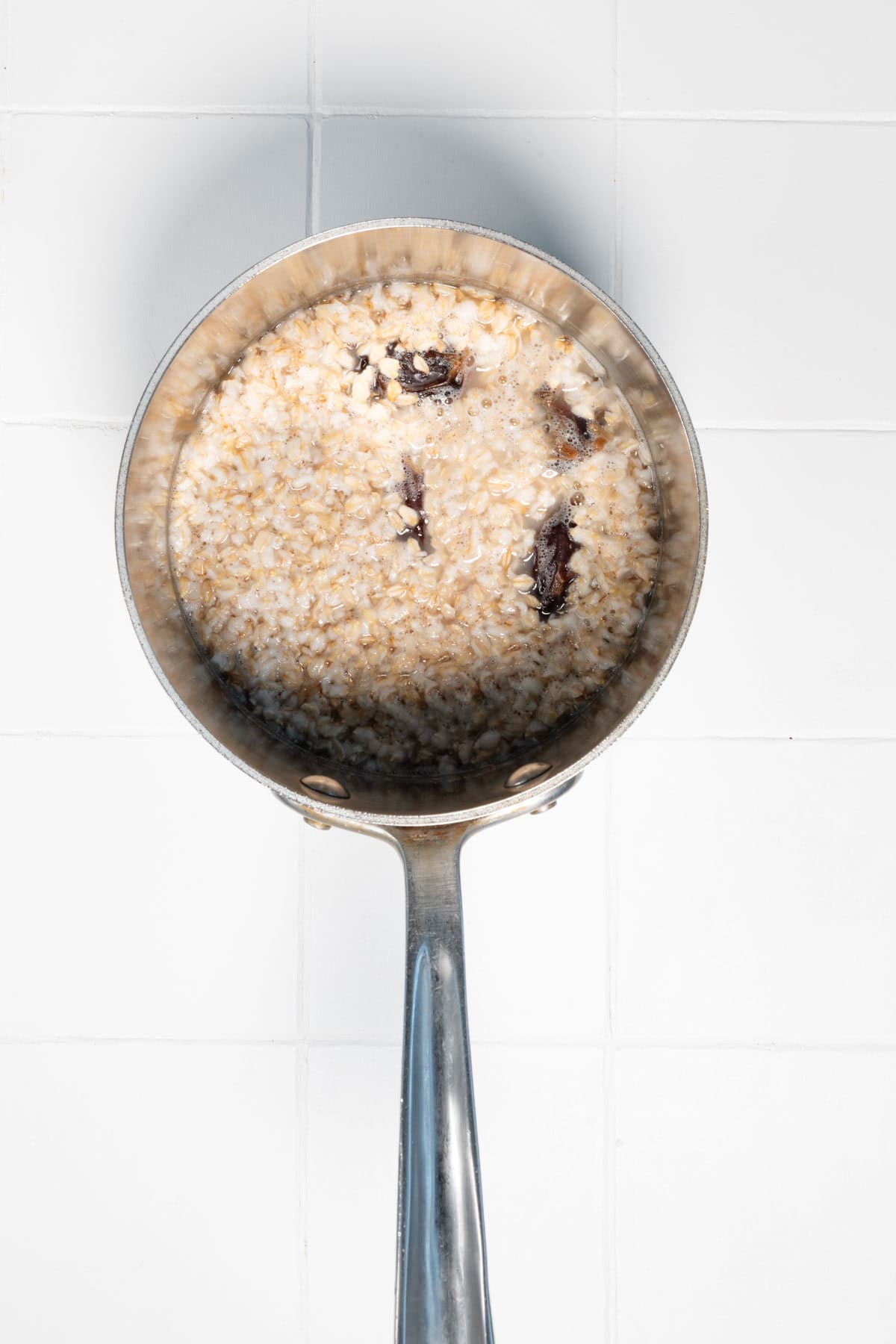 Rolled oats and Medjool dates soaking in water.