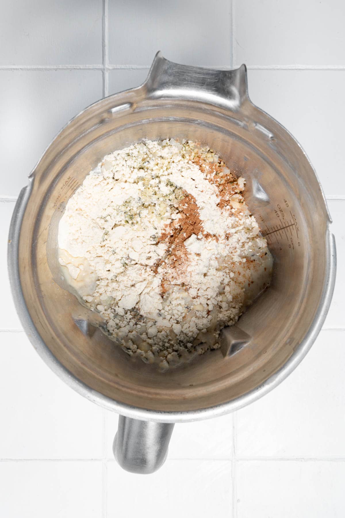 Nondairy milk, hemp hearts, protein powder, cinnamon, cardamom, soaked oats and dates, banana, chickpeas, and frozen cauliflower rice in a blender.