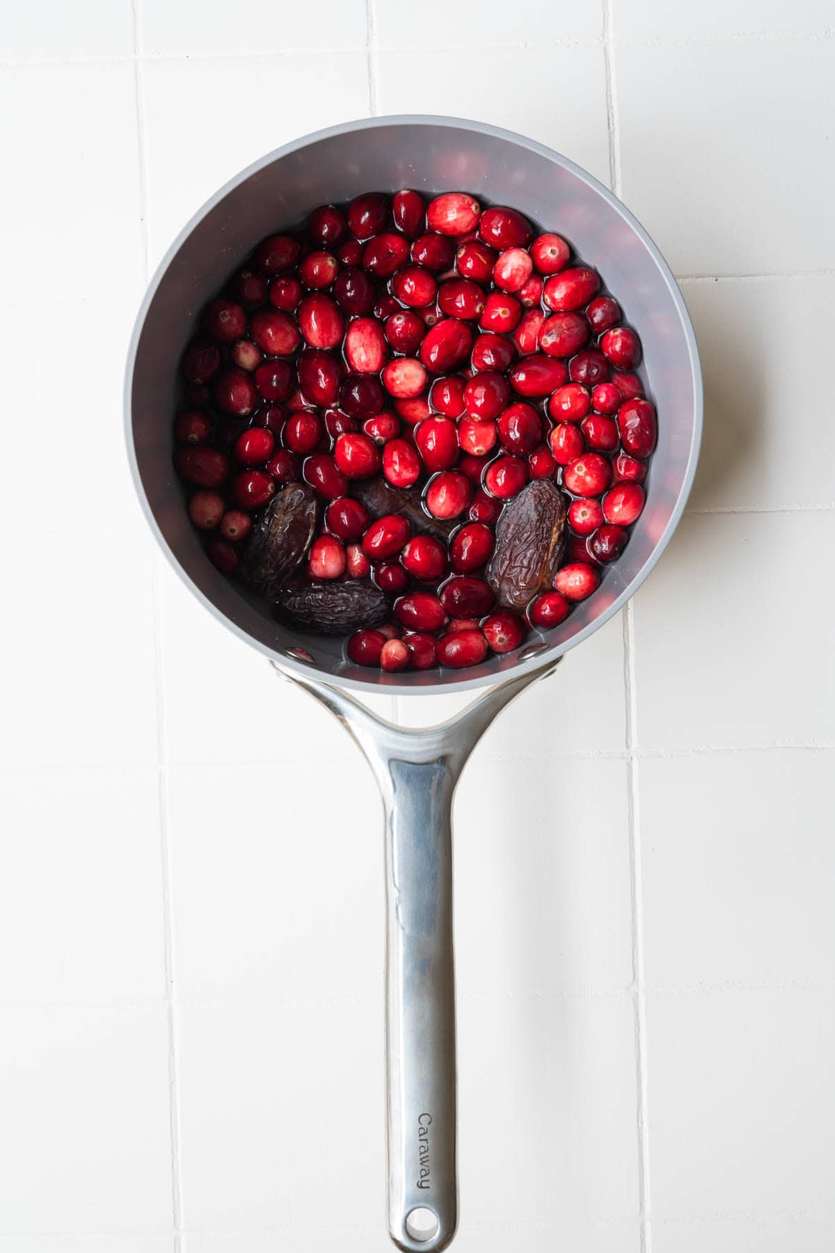 Cranberries simmering in water with dates.
