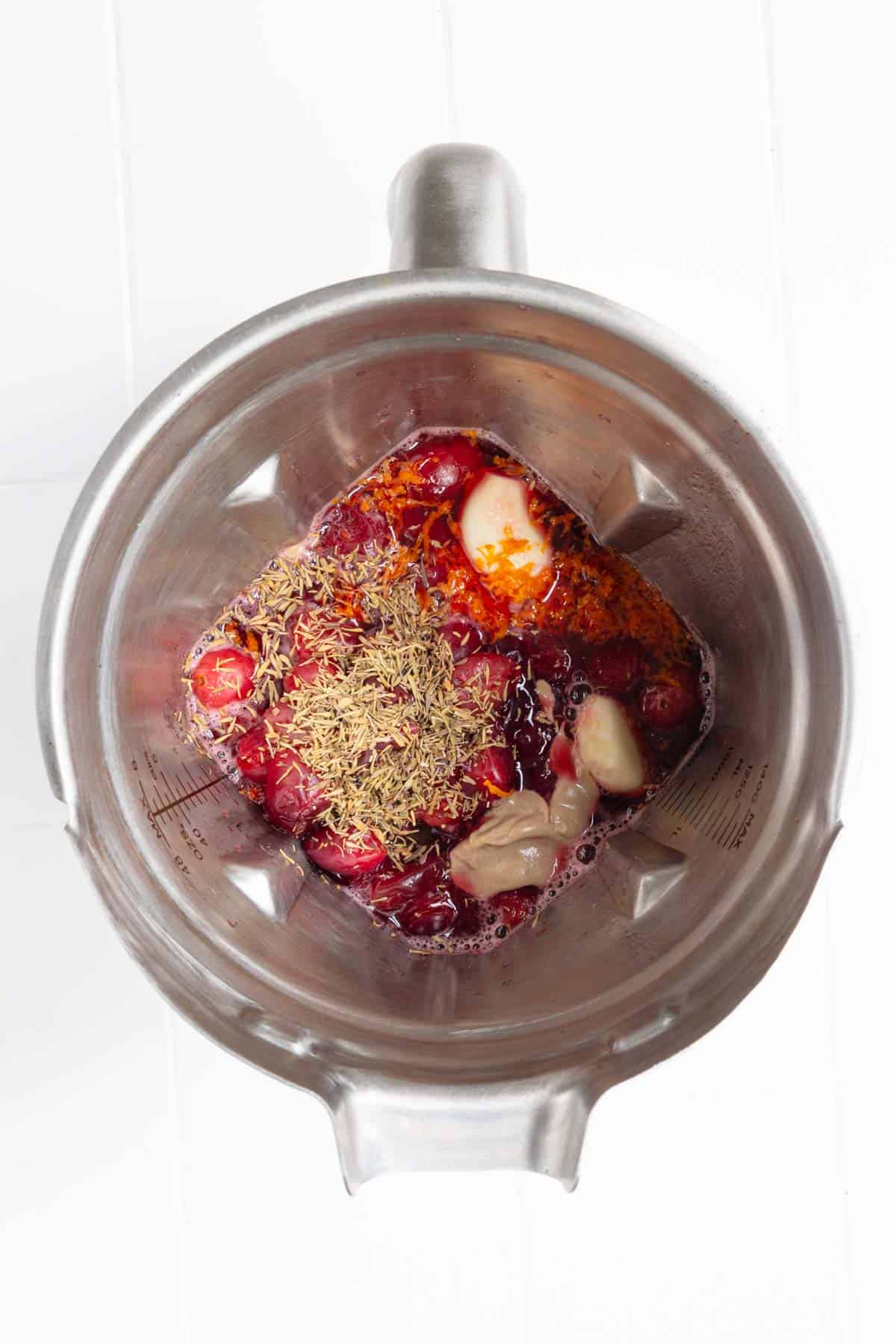 Garlic, dried herbs, cooked cranberries, Dijon mustard, orange juice, and garlic in a blender.
