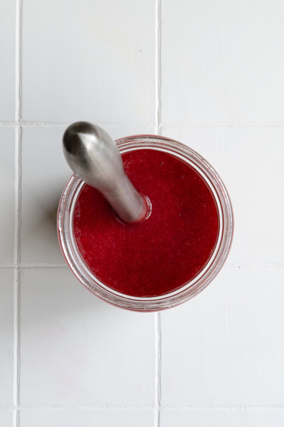 Whisked cranberry balsamic dressing in a jar.