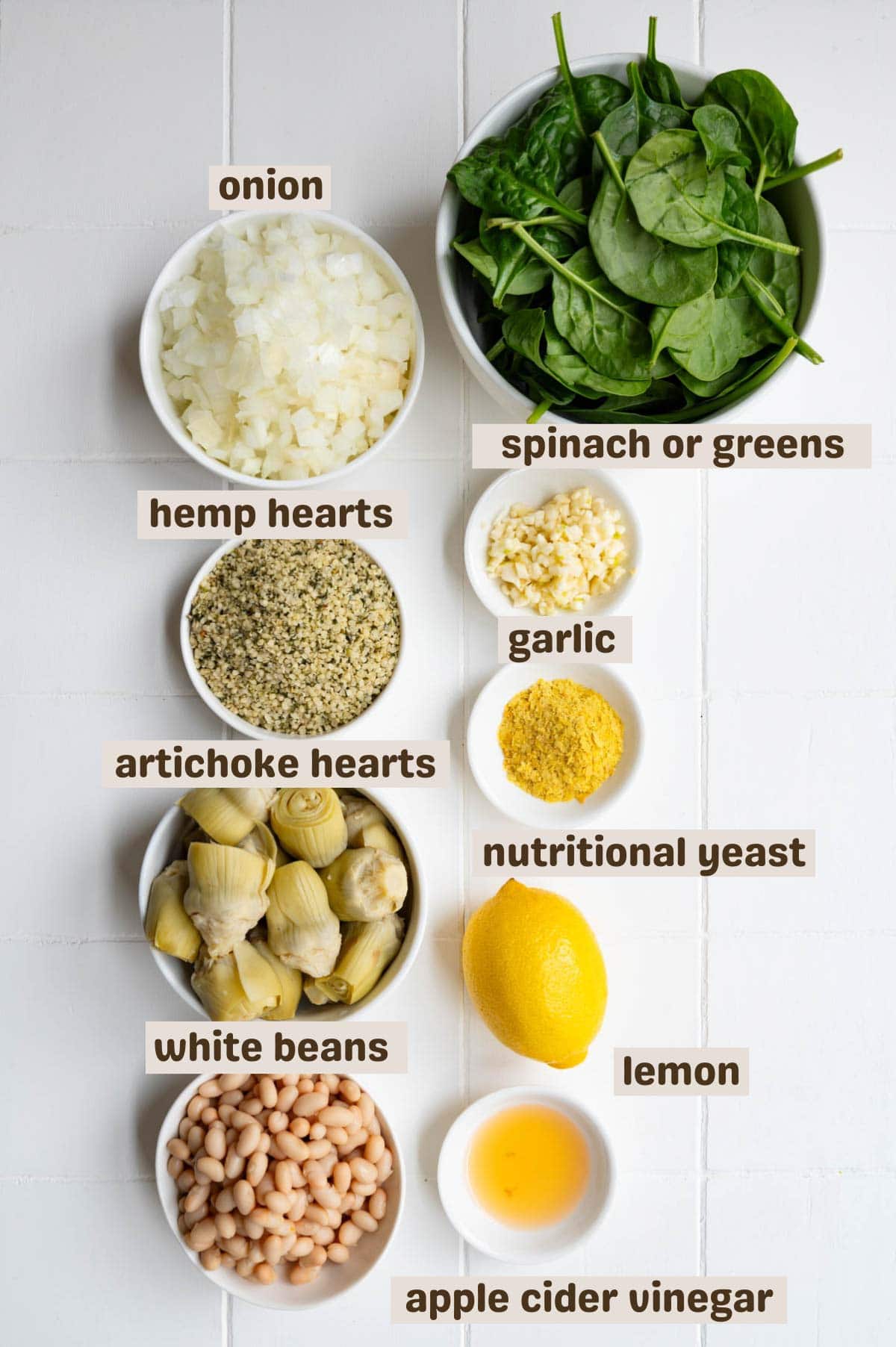 Chopped onion, baby spinach, minced garlic, hemp hearts, nutritional yeast, artichoke hearts, lemon, white beans, and apple cider vinegar.
