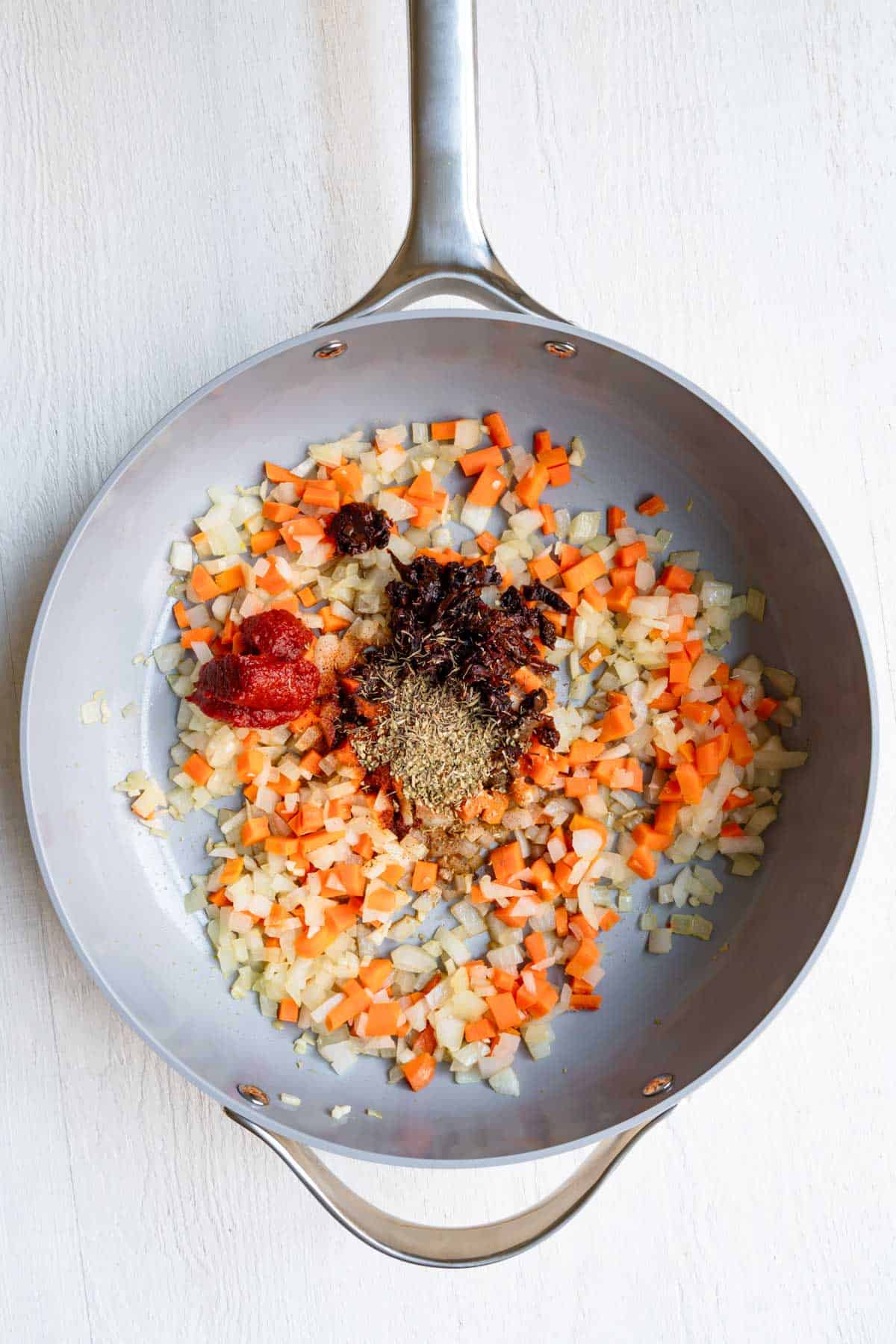 Sautéd aromatics, carrots, sun-dried tomatoes, tomato paste, and herbs.