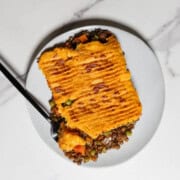 Vegetarian Lentil Shepherd's Pie on a plate with a fork.