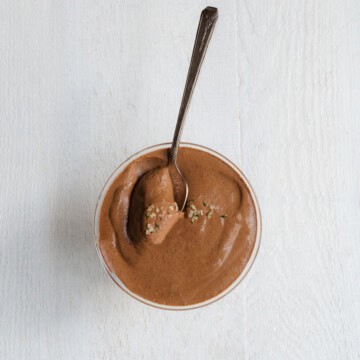 High-Protein Chocolate Chia Pudding in a glass bowl with a spoon.