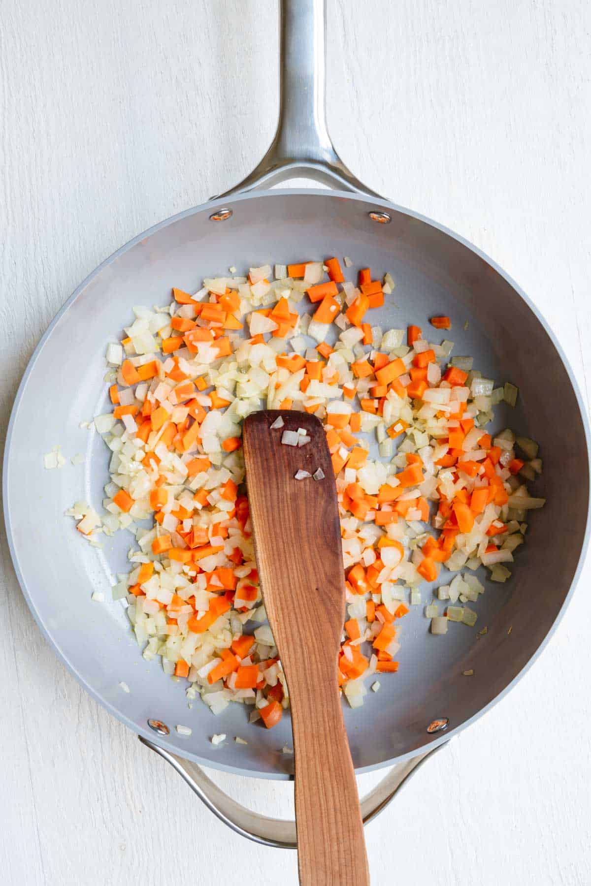 Sautéd onion, garlic, and carrot in a skillet.