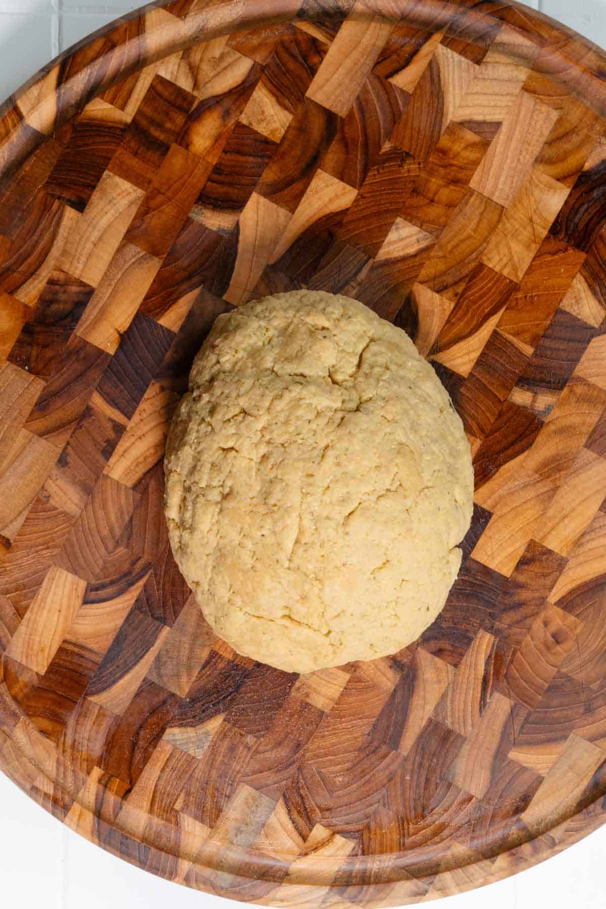Vital what gluten dough shaped oval on a wooden cutting board.