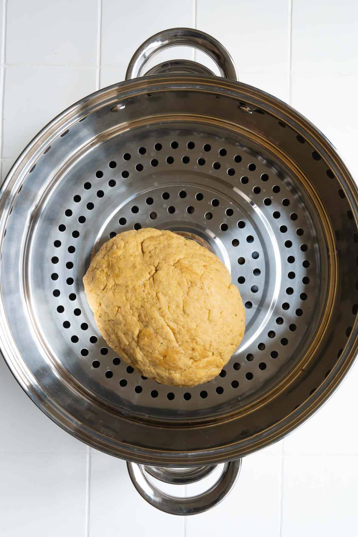 Gluten oval-shaped dough in a large steamer.