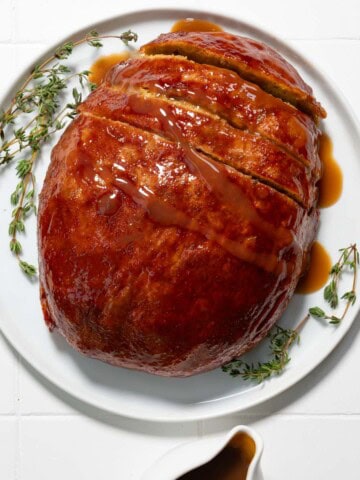 Thanksgiving Vegan Turkey on a white plate with gravy.