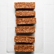 Six homemade high-protein granola bars(no bake) on white parchment paper.