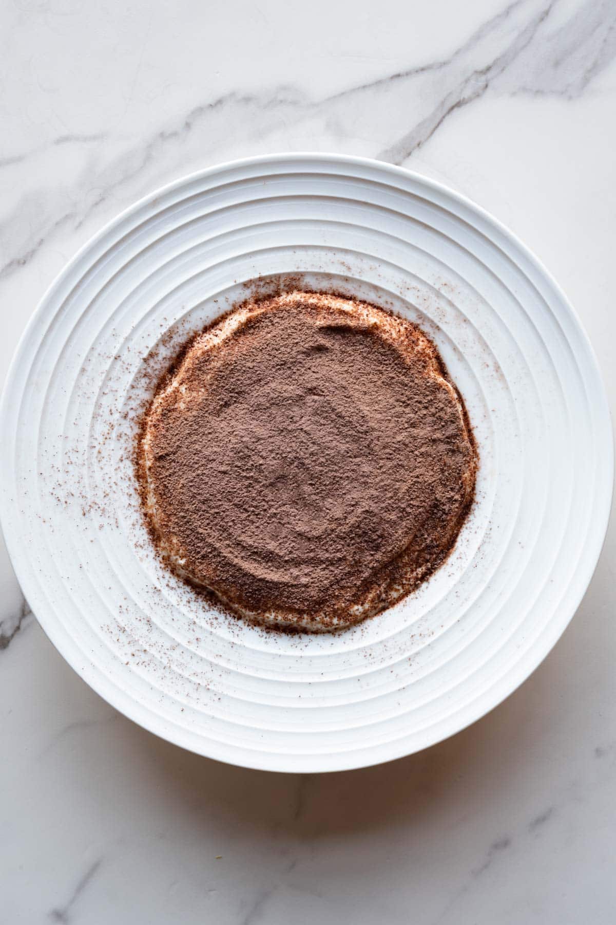 Tiramisu oats in a white bowl.