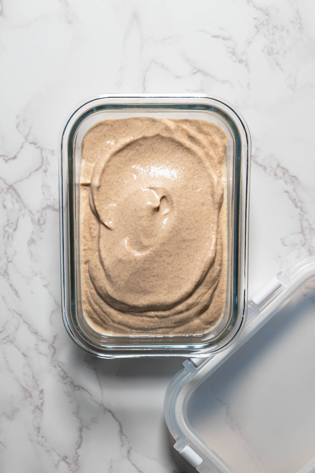 Walnut cream frosting in a glass dish.