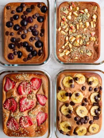 Baked red lentil protein pancakes with toppings in four meal prep glass containers.