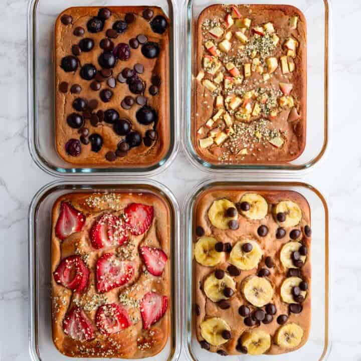 Baked red lentil protein pancakes with toppings in four meal prep glass containers.