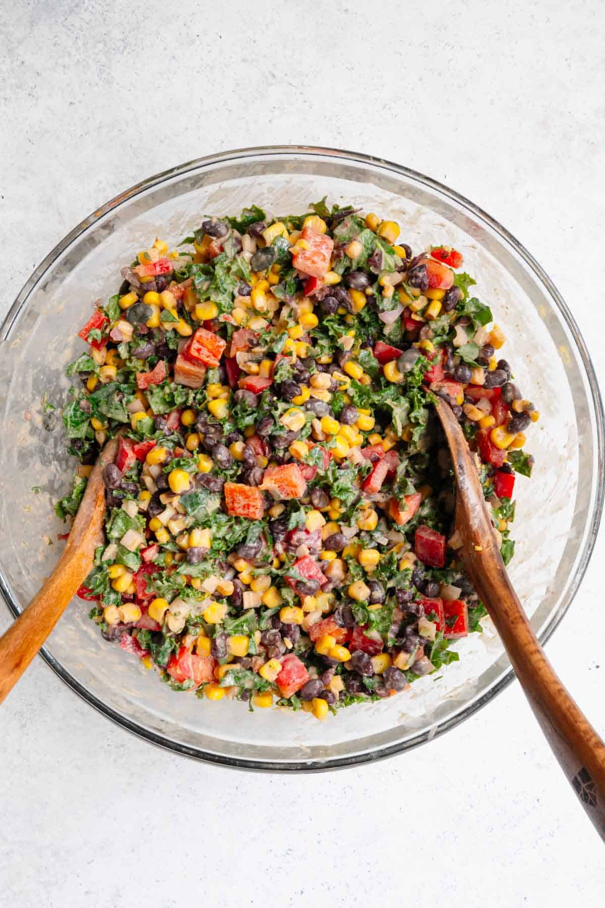 Black bean, corn, and avocado salad mixed in a bowl.