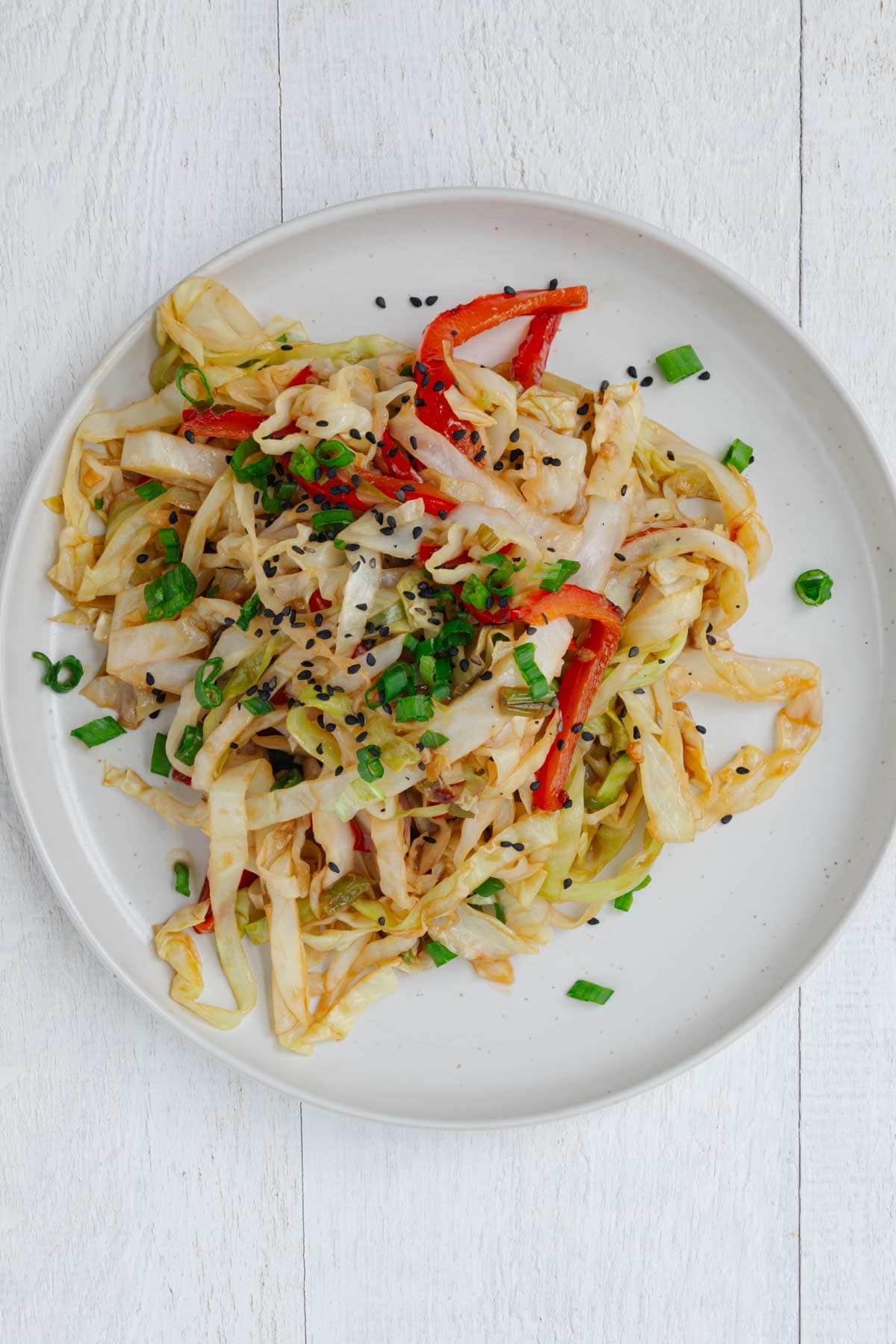 Cabbage stir-fry on a white plate.