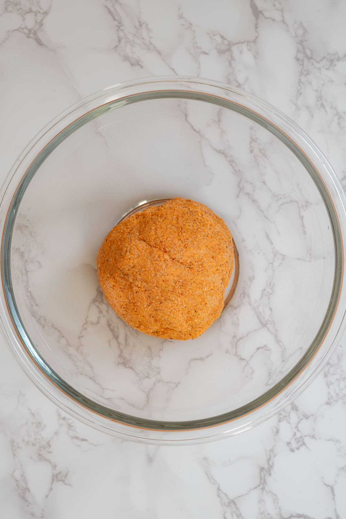 Rolled red lentil and psyllium husk dough in a glass bowl.