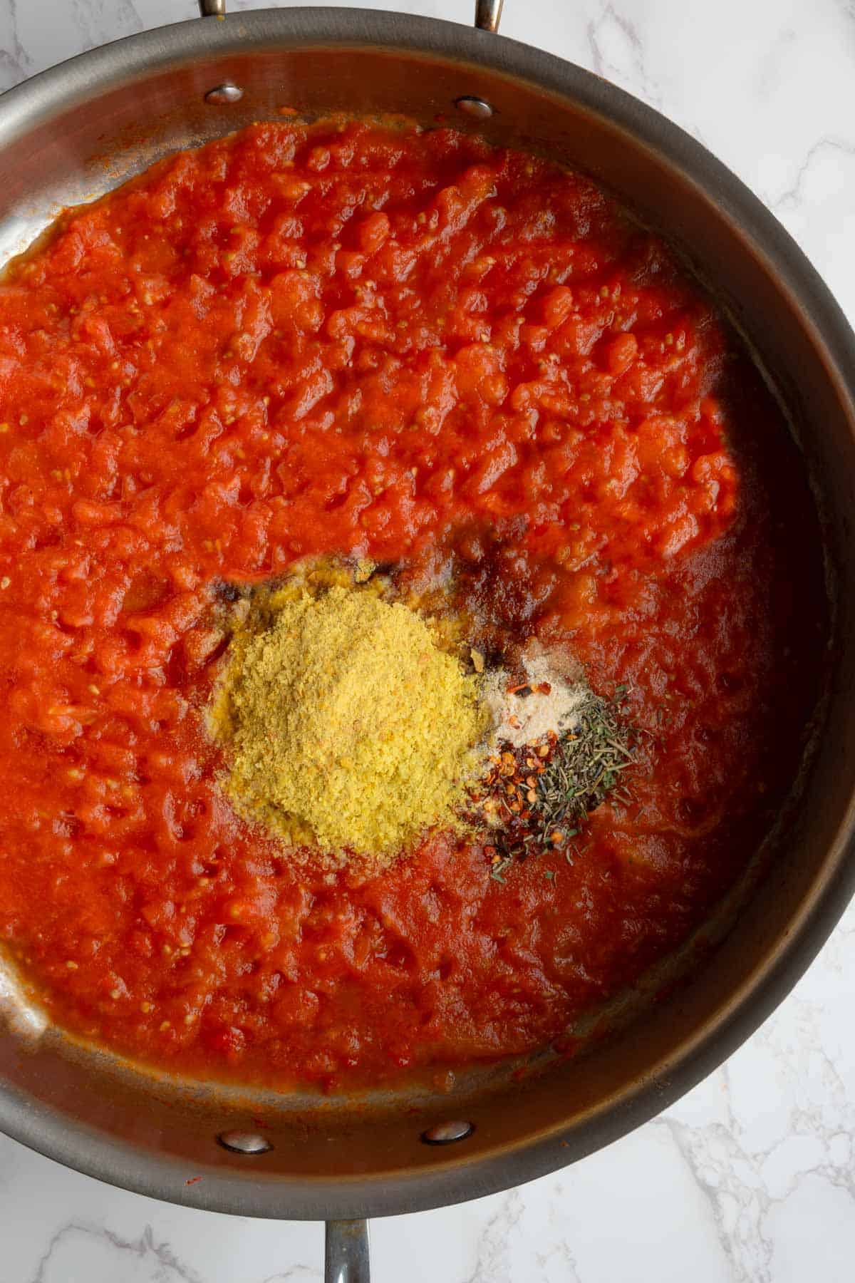 Cooked tomatoes with nutritional yeast, date syrup, balsamic vinegar, coconut aminos, dried herbs, and crushed red pepper.