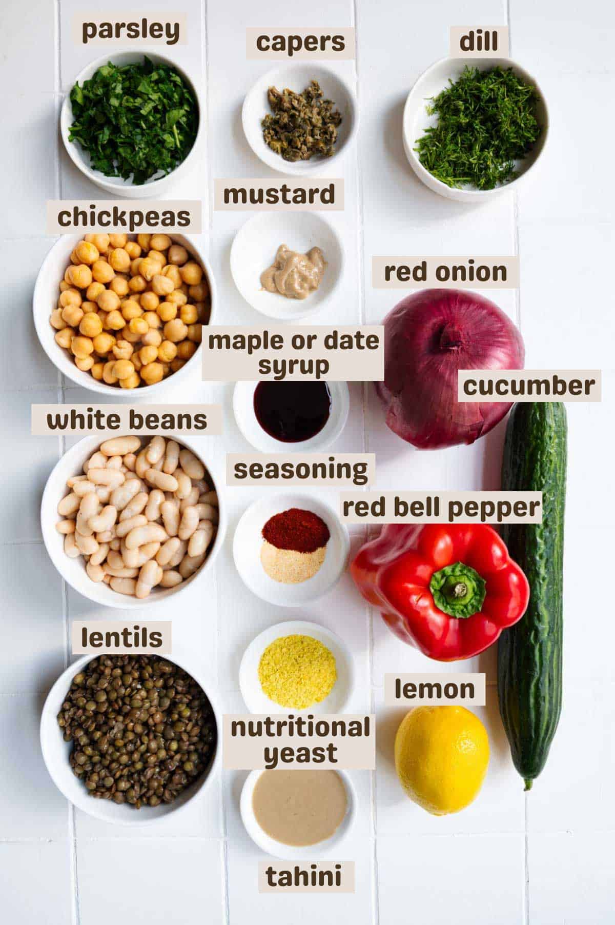 Parsley, capers, dill, chickpeas, lentils, date syrup, mustard, red onion, cucumber, seasoning, nutritional yeast, tahini, garlic powder, smoked paprika, red bell pepper, cucumber, and lemon.
