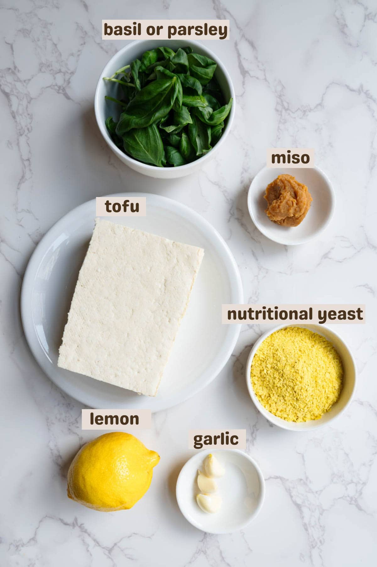 Tofu, miso, nutritional yeast, garlic, lemon, and basil.