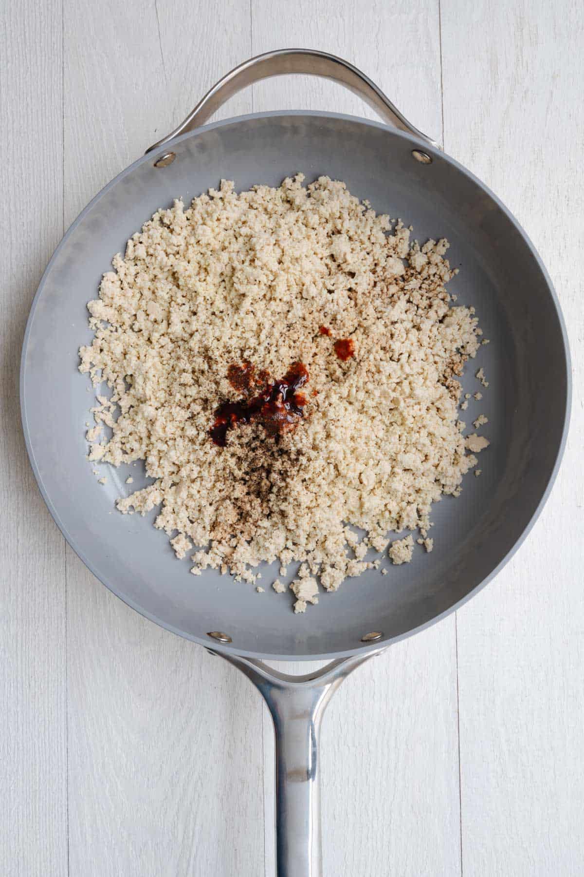Crumbled tofu and seasonings in a skillet.