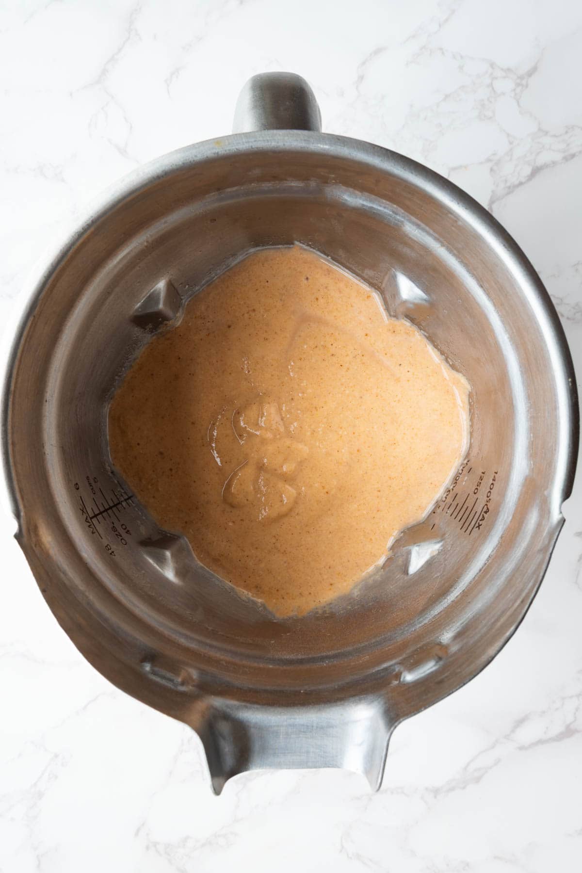 Blended protein pancake batter in a steel blender.