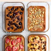Baked red lentil protein pancakes with toppings in four meal prep glass containers.