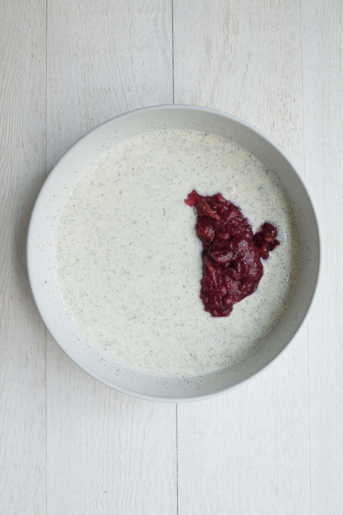 Nondairy milk whisked into Greek yogurt with ground chia seeds and cooked mashed strawberries and dates.