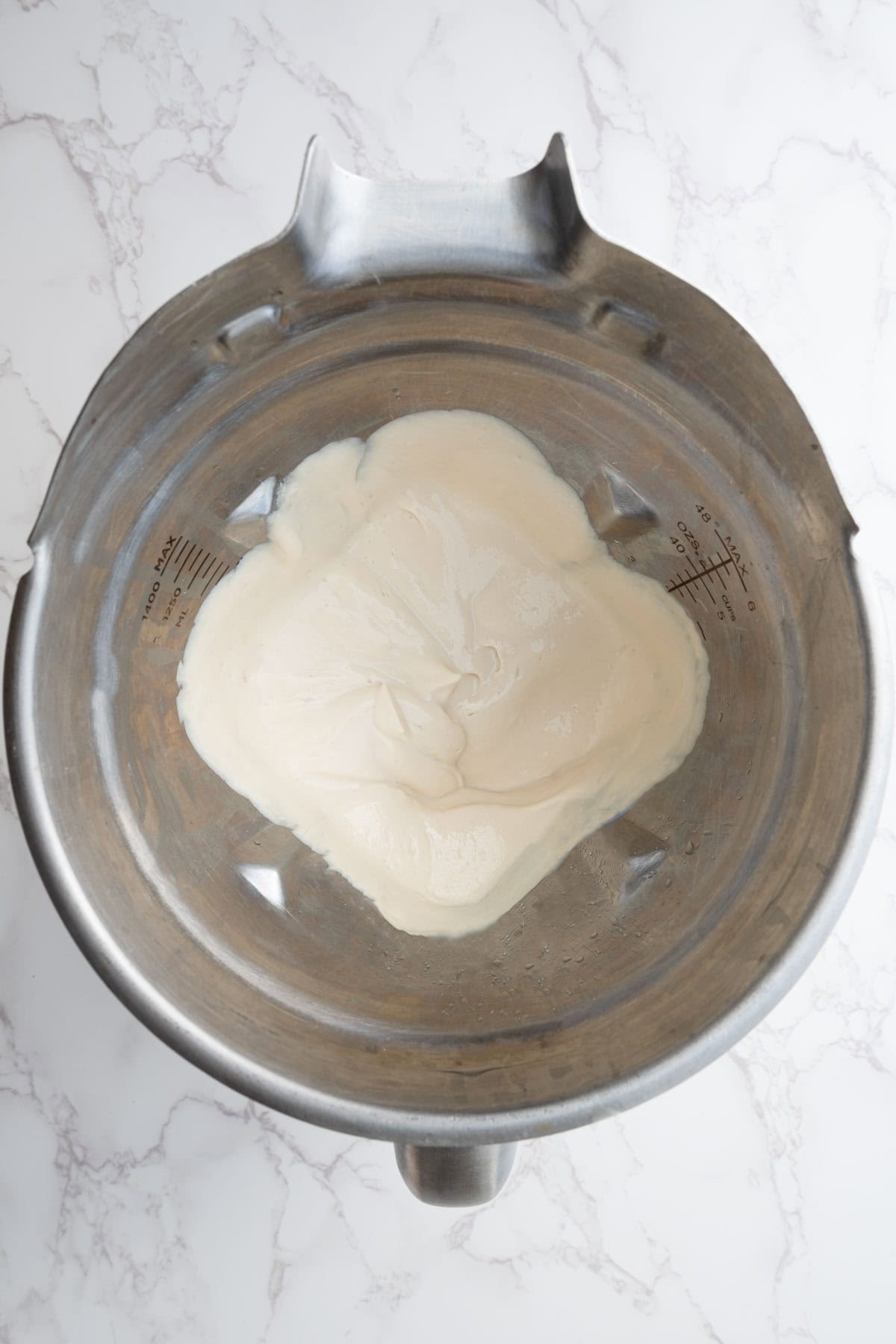 Blended white cream in a blender.