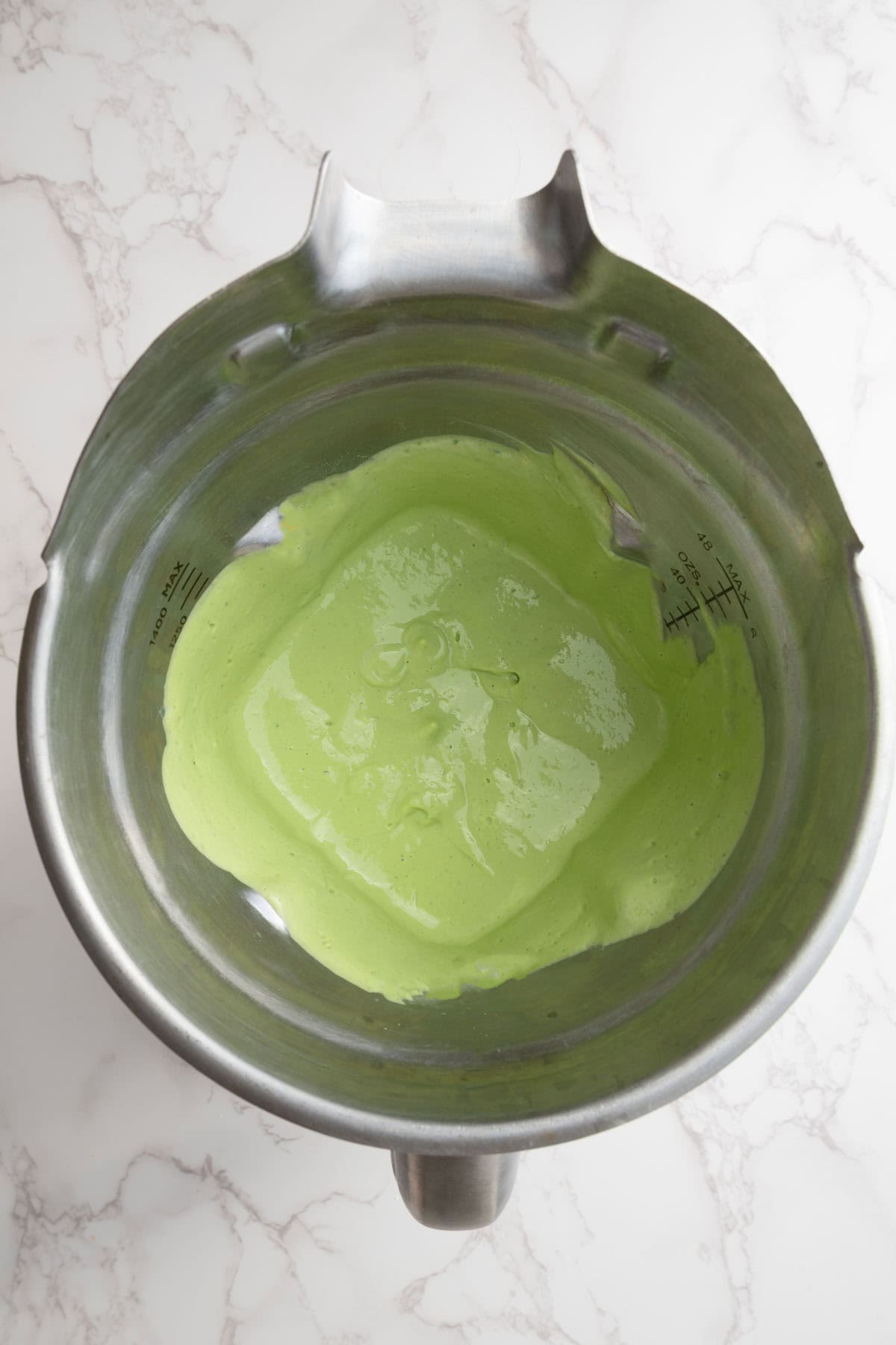 Green sauce in a blender.