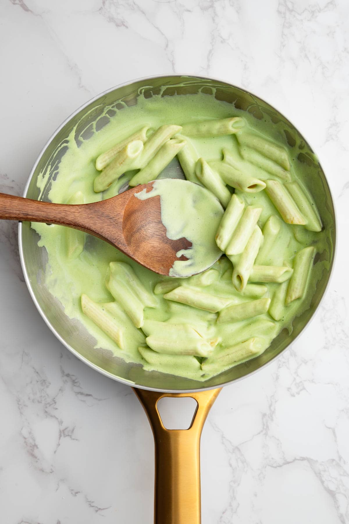 High-protein tofu pesto with pasta in a saucepan.