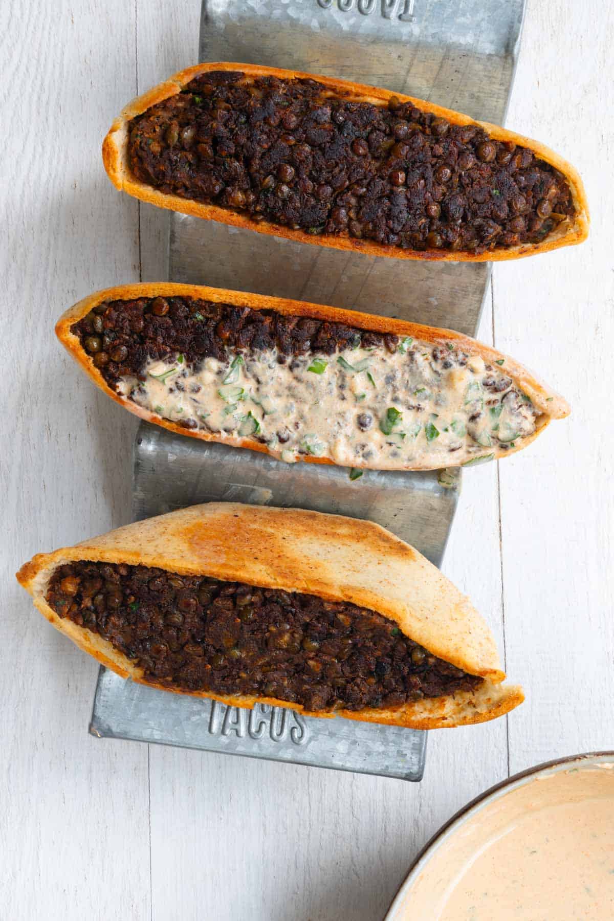 Three arayes stuffed with lentils with Greek yogurt dressing.