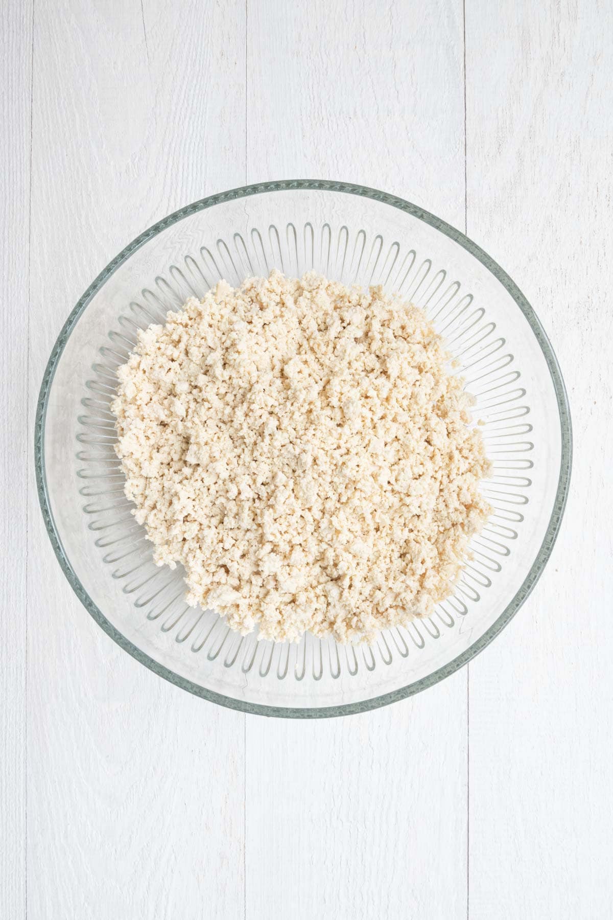 Crumbled tofu in a glass bowl.