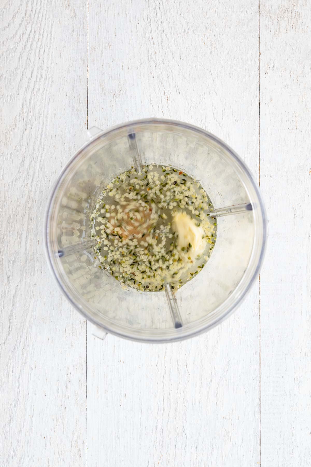 Hemp seeds, miso, water, garlic, and lemon juice in a blender.
